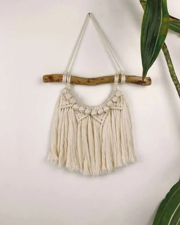 Mini painel de macramé Sunset com nós em arco, pendurado num ramo curvo